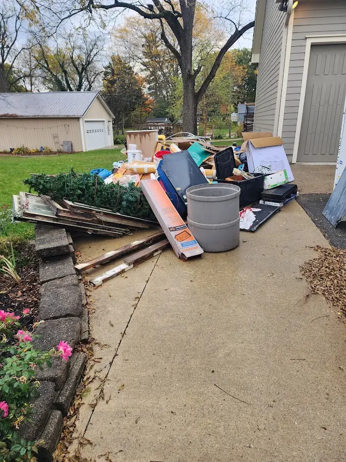 Dumpster being loaded with debris for 12 Yard Dumpster Rental in Crockett